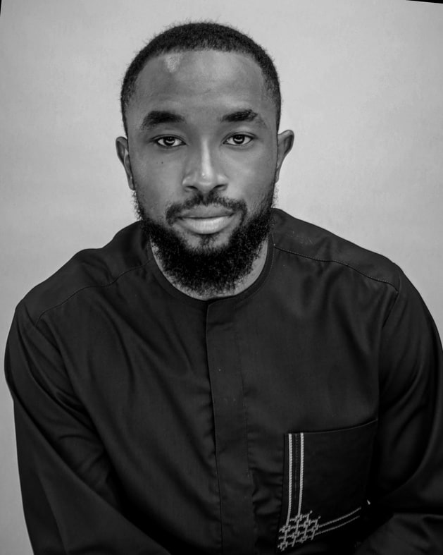 Black and white studio portrait of Daniel Okafor, Principal Visual Strategist and Creative Director.